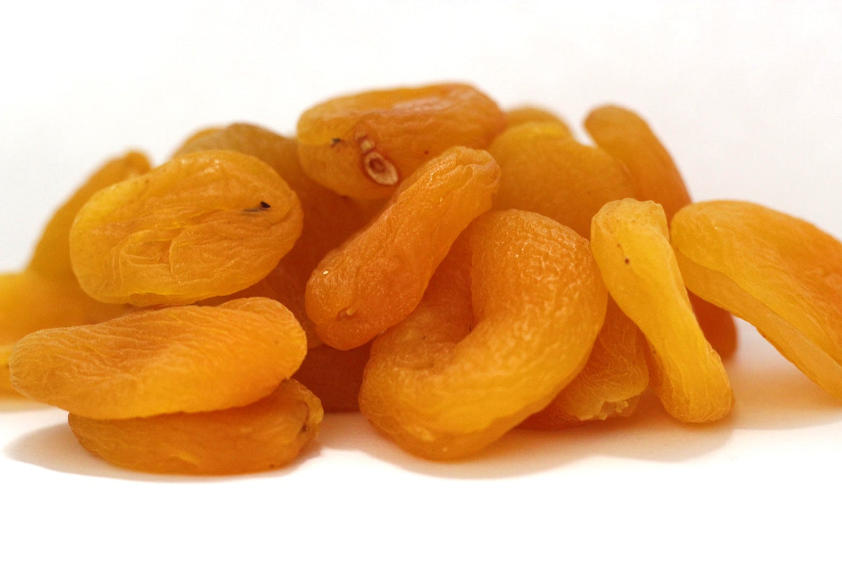 Apricots, whole and halved dried apricot pieces in a loose pile