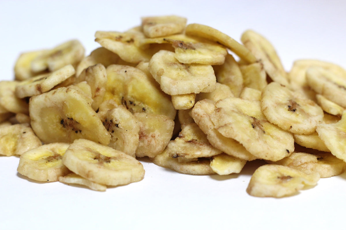 Banana Chips, thin round banana slices piled loosely, with curved edges and pale golden color