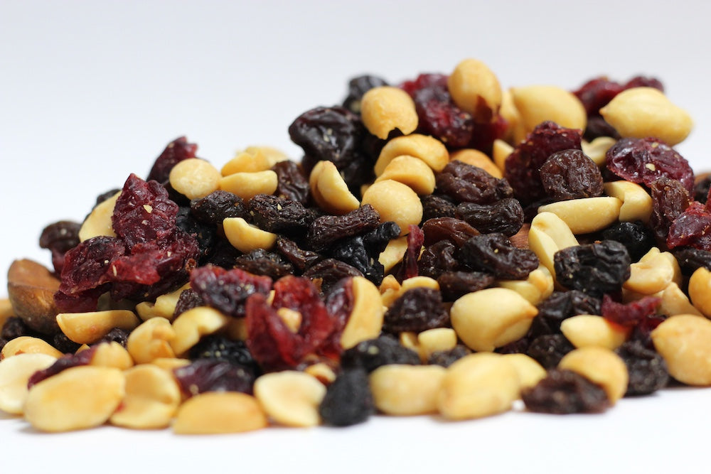 Very Berry Very Nutty Blend with whole cashews, almonds and peanuts with dried cherries and blueberries in a loose pile