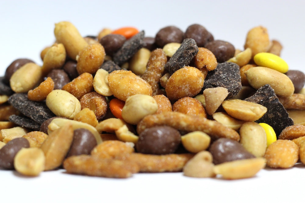 Chocolate Peanut Butter Swirl with whole peanuts, chocolate raisins, sesame sticks and peanut butter chips in a loose pile