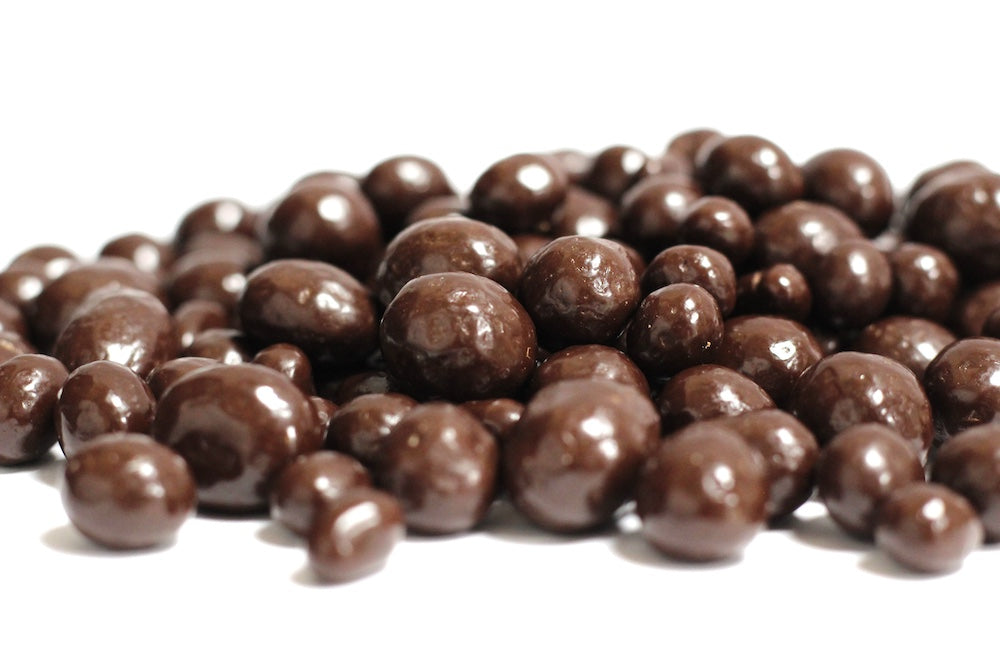 Dark Chocolate Coffee Beans, whole dark chocolate-coated coffee beans piled in a loose heap