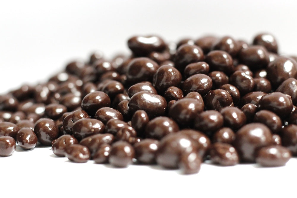 Dark Chocolate Ginger, small ginger pieces coated in dark chocolate in a loose heap