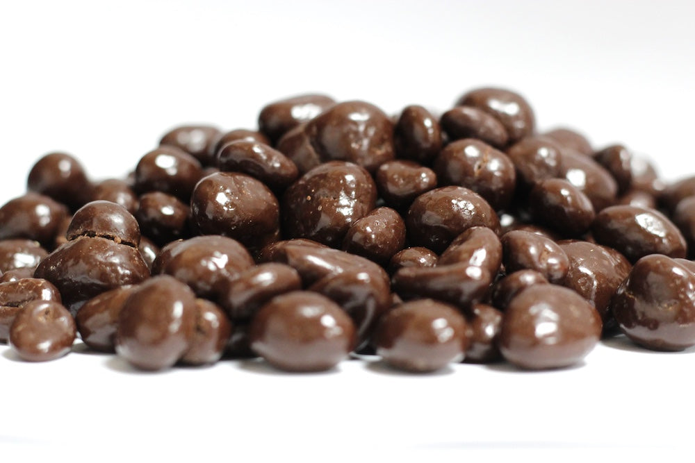 Dark Chocolate Peanuts, whole roasted peanuts coated in dark chocolate in a loose heap