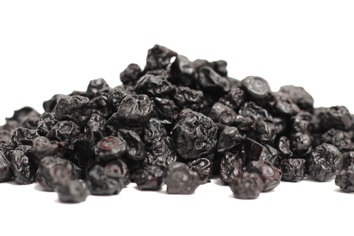 Dried Blueberries, whole wrinkled berries in a loose heap with deep purple-blue color