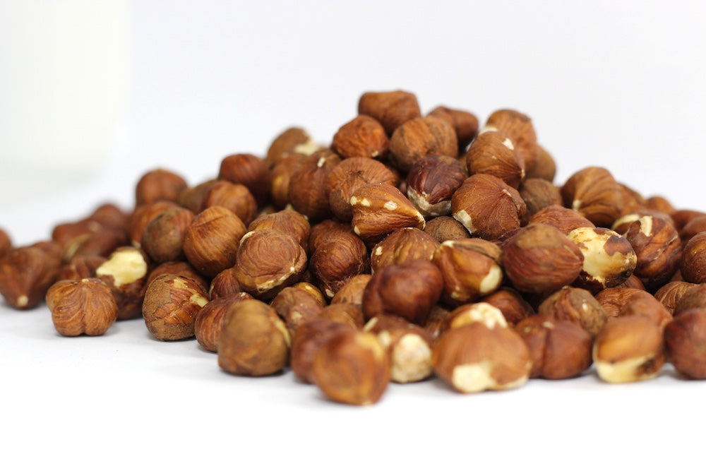 Filberts, whole roasted hazelnuts with brown skins in a loose pile