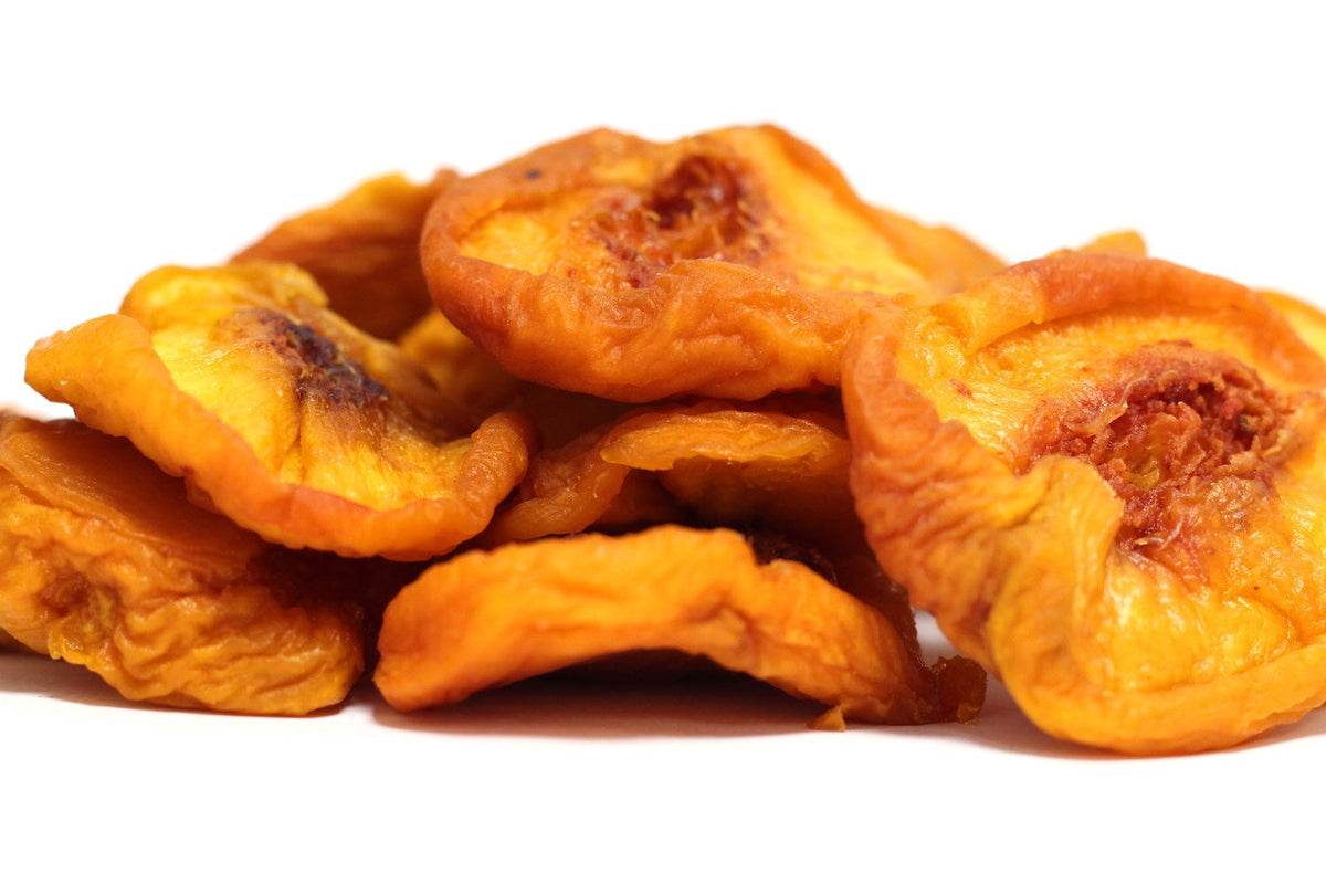 Jumbo Peaches, large dried peach halves in orange and golden tones in a loose heap