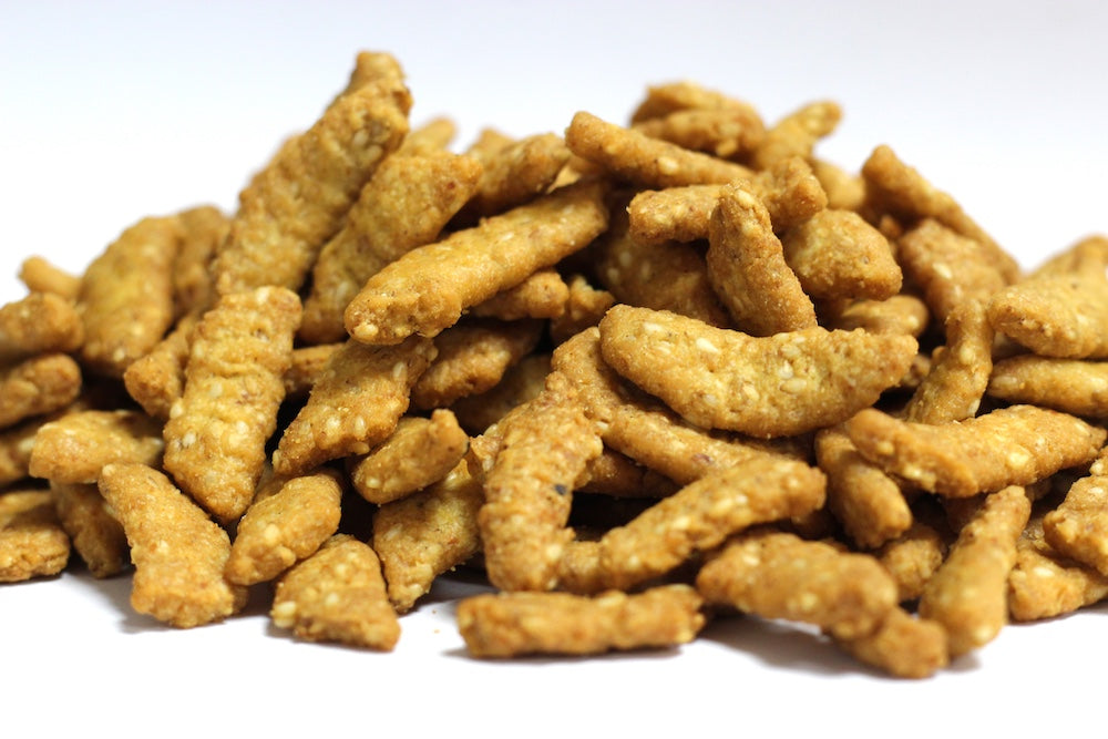 Oat Bran Sesame Sticks, a loose heap of whole sticks coated with sesame seeds