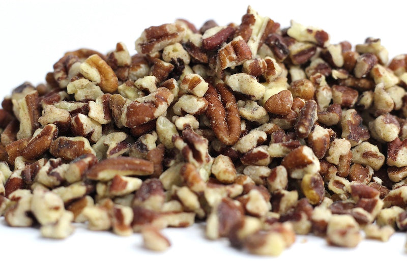 Pecan Pieces in a loose heap of irregularly shaped pecan pieces