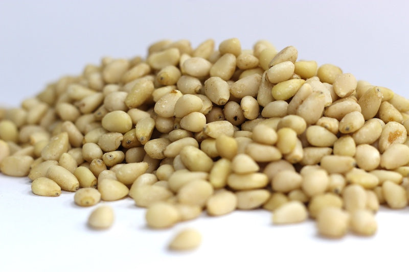 Pine Nuts: a loose heap of whole, ivory-colored pine nut kernels