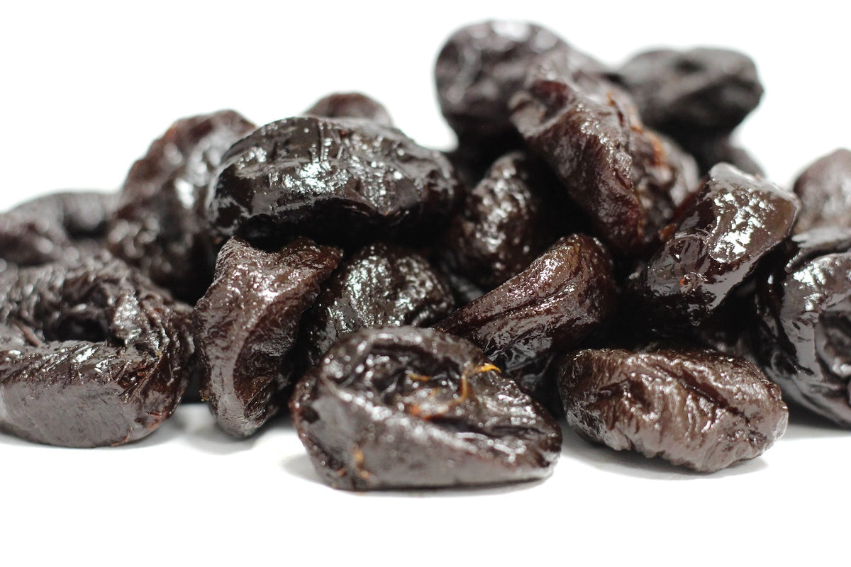 Pitted Prunes, whole wrinkled dark purple-black prunes piled in a loose heap