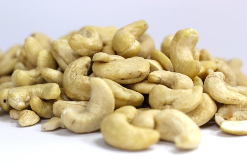 Raw Cashews, whole pale ivory cashews in a loose pile