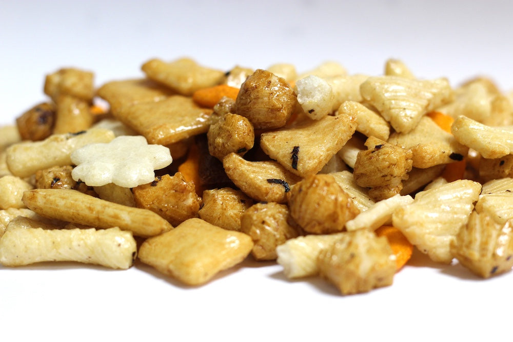 Rice Crackers, whole and broken crisp pieces in varied shapes in a loose pile
