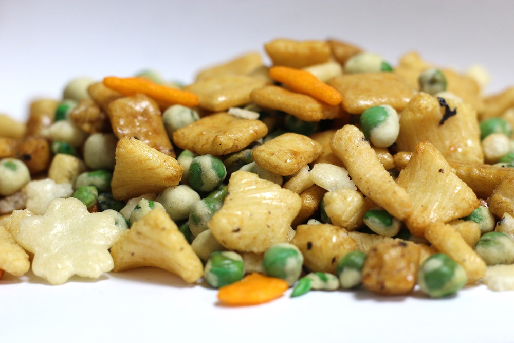 Rice Crackers and Wasabi Peas, whole rice crackers and green wasabi peas in a loose heap