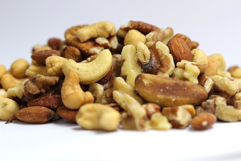 Roasted, No Salt Deluxe Mixed Nuts, whole almonds, cashew pieces, and pecan halves in a loose heap