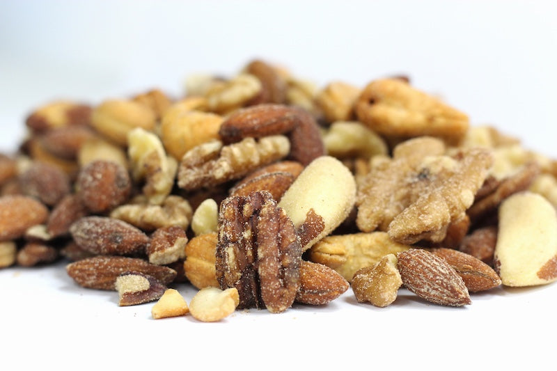 Roasted, Salted Deluxe Mixed Nuts in a loose heap with whole cashews, almonds, pecan halves and Brazil nut pieces