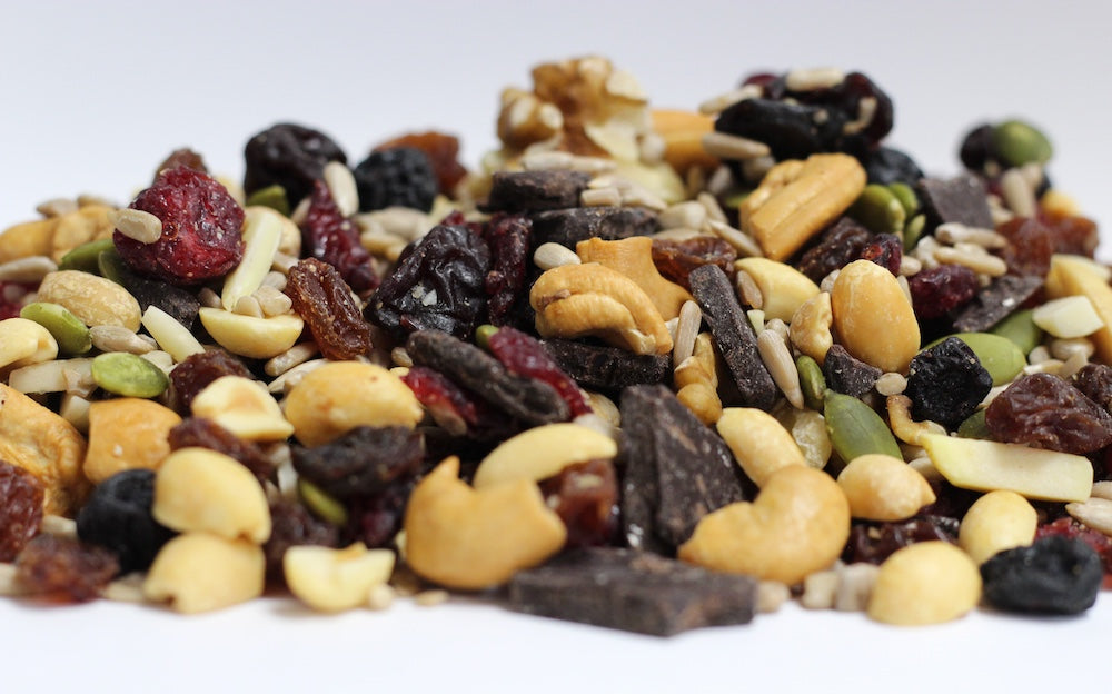 Dark Chocolate and Triple Berry Antioxidant with whole dried cherries, blueberries, cranberries, and dark chocolate chunks in a loose pile