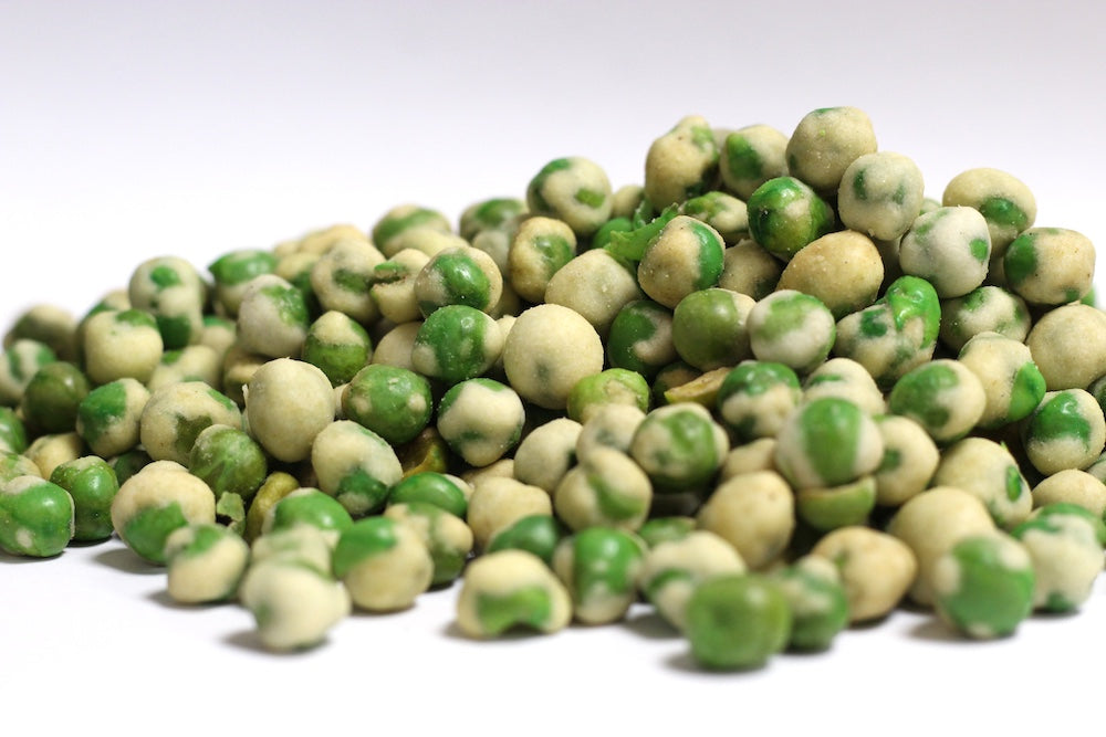 Wasabi Peas: whole green peas coated in irregular, pale green wasabi-seasoned shells in a loose pile